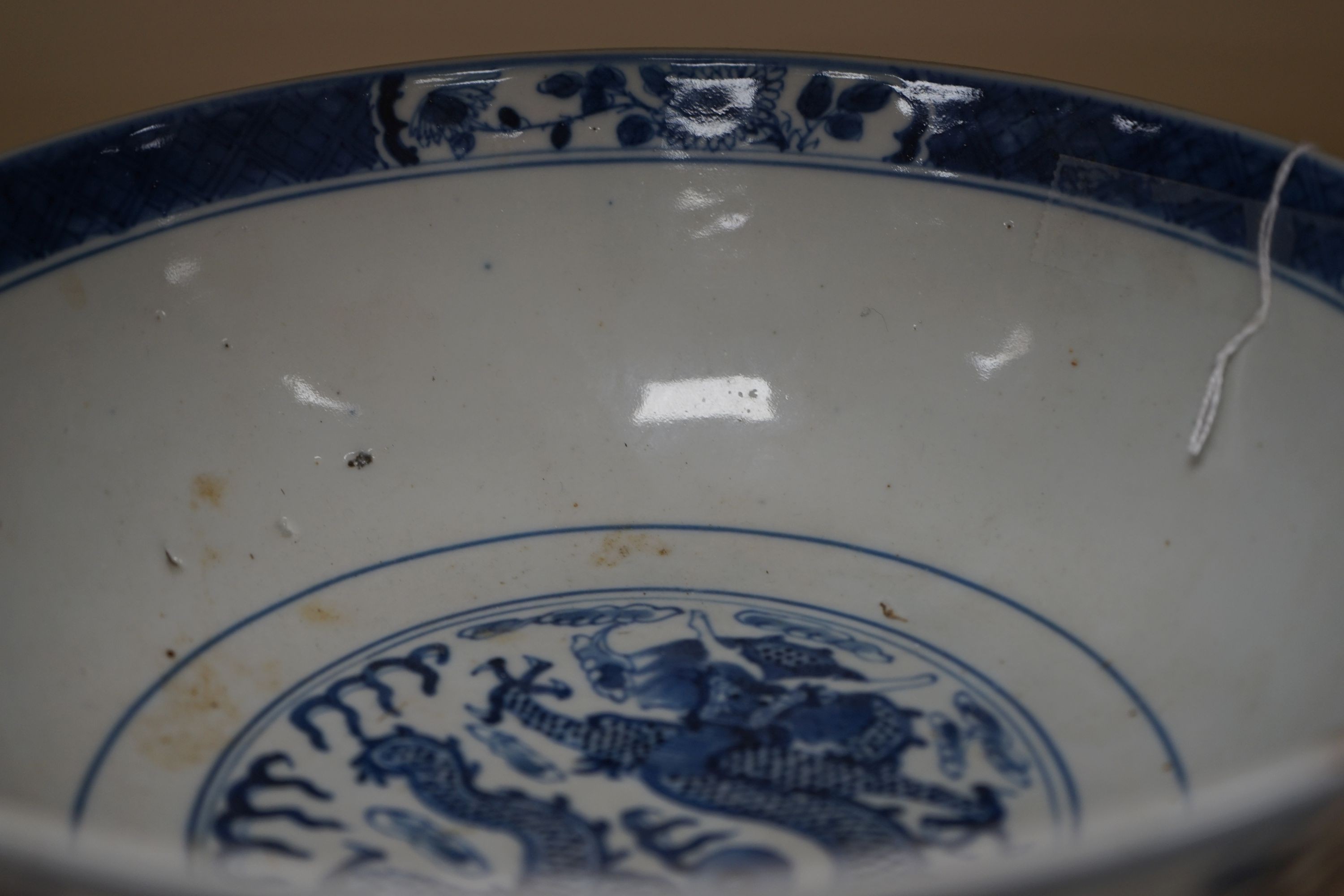 A Chinese blue and white ‘dragon’ bowl, Kangxi mark, late 19th century 25cm